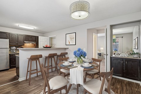A kitchen with a dining table set for four.