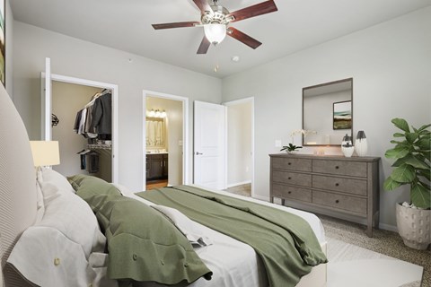 A bedroom with a bed, dresser, and mirror.