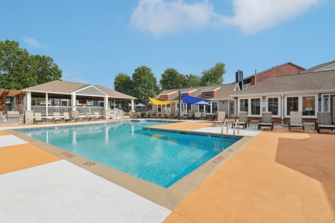 A large swimming pool with a yellow and white striped border.