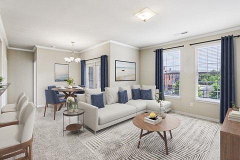 A living room with a white sofa, a coffee table, and a painting on the wall.
