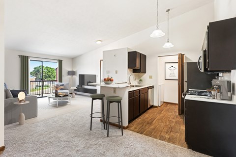 A modern kitchen with dark wood cabinets and a white countertop.