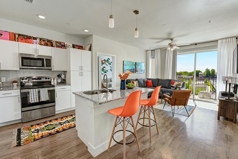 A modern kitchen with white cabinets and a large island.