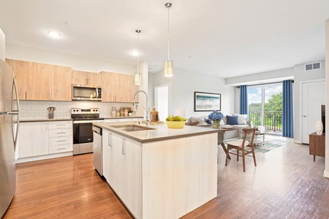 A modern kitchen with wooden cabinets and a large island.