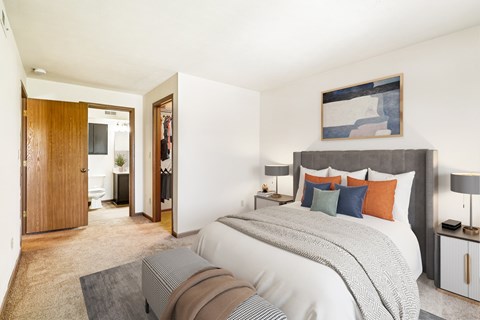 A bedroom with a large bed and a painting on the wall.