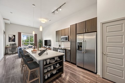 A modern kitchen with a dining table and chairs.
