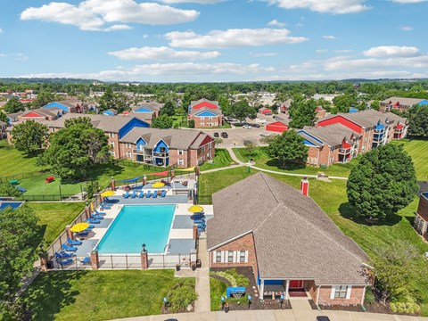 A large swimming pool surrounded by a fence and a grassy area.