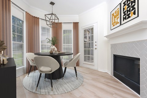A modern dining room with a black table and chairs.