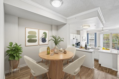 A dining room with a table and chairs.