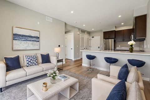 A living room with a white couch and a coffee table.