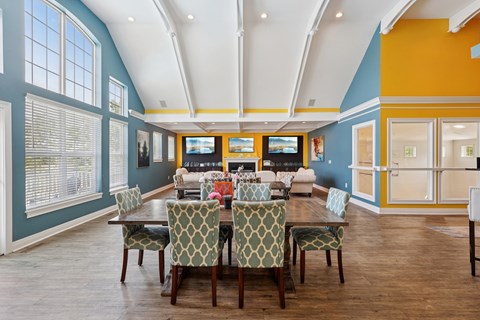 A dining room with a table set for six.