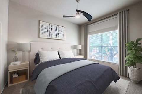 A bedroom with a large bed and a ceiling fan.