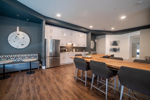 A modern kitchen with a wooden table and chairs.