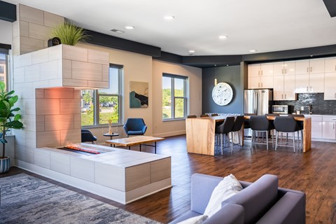 A modern living room with a grey couch and a wooden coffee table.