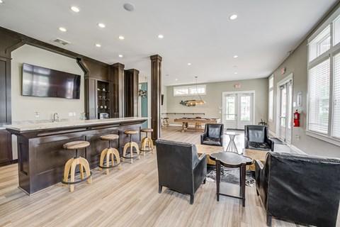 A modern living room with a bar area and a fireplace.