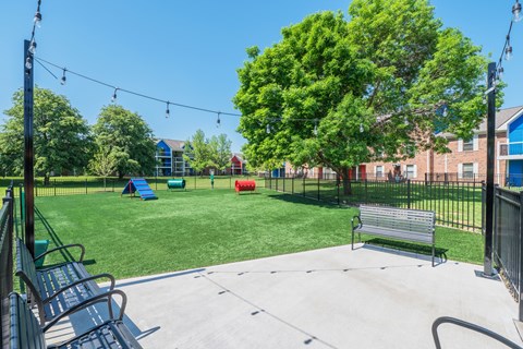 A park with a playground and a bench.