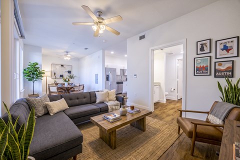 A living room with a grey couch and a brown leather chair.