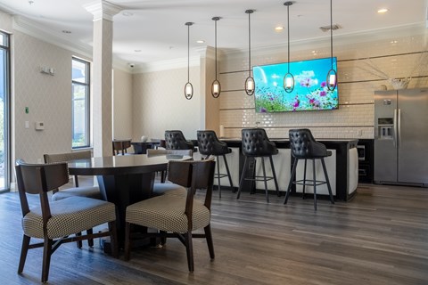 A modern dining room with a large table and chairs.