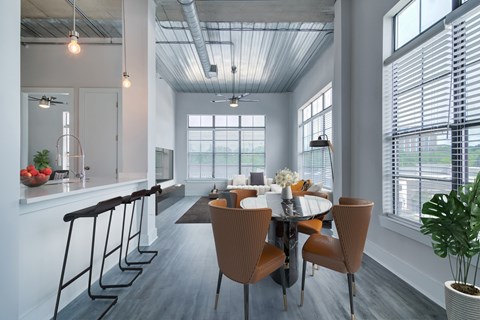 A modern dining room with a large table and chairs.