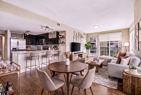 A modern open-concept living space with a kitchen, dining area, and seating area.