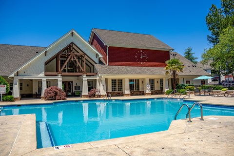 A large house with a pool in front.