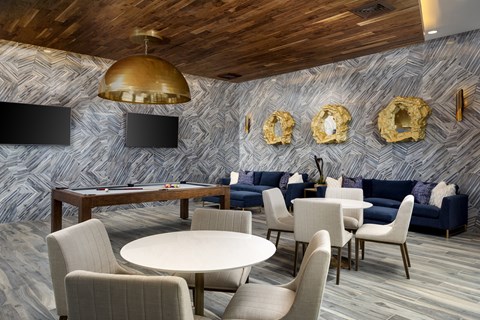 A modern dining room with a round table and chairs.