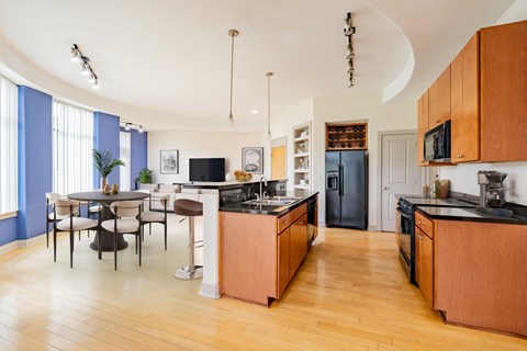 A kitchen with wooden cabinets and a dining table with chairs.