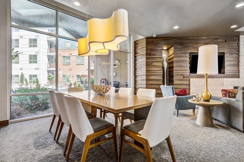 A dining room with a table and chairs.