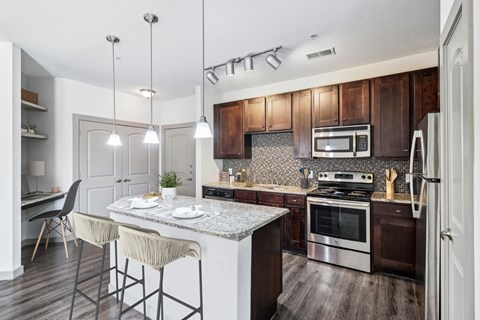 A modern kitchen with a dining table and chairs.