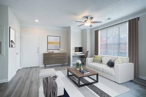 A modern living room with a white couch and a wooden coffee table.