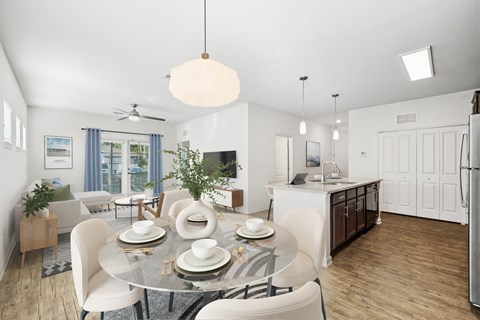 A modern dining room with a glass table and white chairs.
