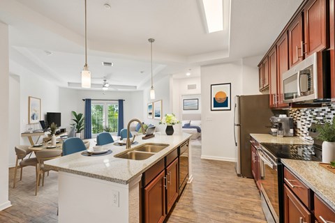 A kitchen with a white counter top and wooden cabinets.