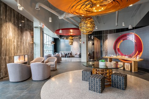 A modern living room with a glass table and a fireplace.