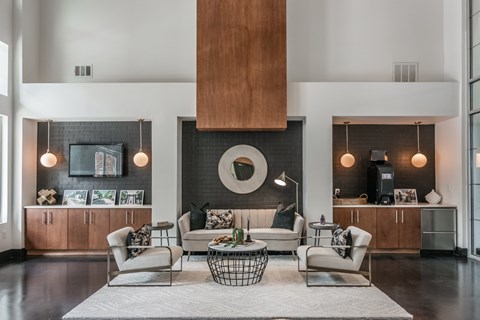 A modern living room with a large sofa set and a fireplace.