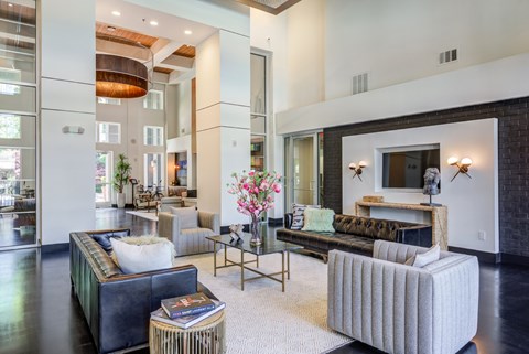 A living room with a grey couch and a coffee table.