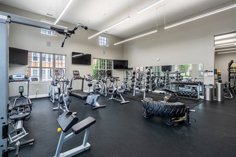 A spacious gym with a variety of equipment including treadmills, weights, and exercise machines.