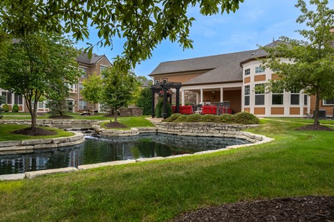 A building with a pond in front of it.