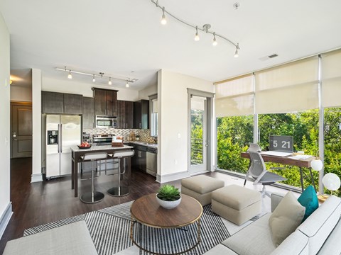 A modern kitchen with a dining table and a couch.