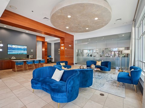 A living room with blue chairs and a blue couch.