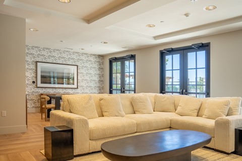 A living room with a large couch and a coffee table.