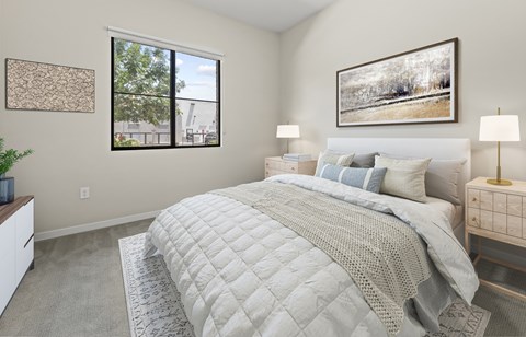 A bedroom with a large bed and a window.
