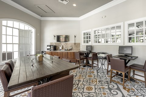 A dining room with a long table and chairs.