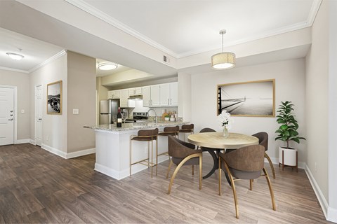 A modern kitchen with a dining table and chairs.