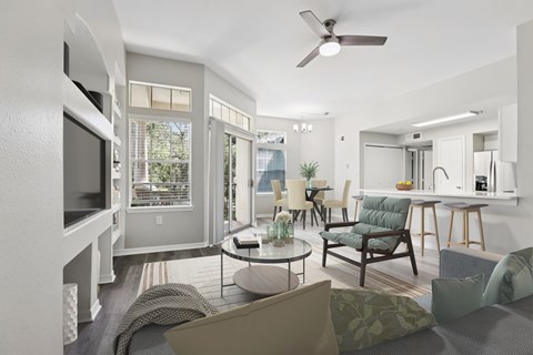 A living room with a grey couch and a green armchair.