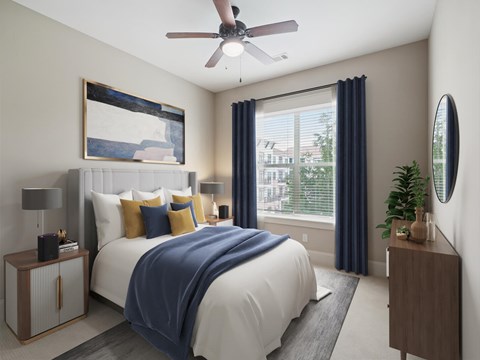 A bedroom with a large bed and a ceiling fan.