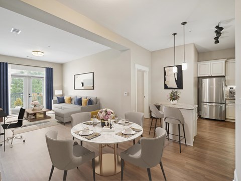 A modern dining room with a table set for four.