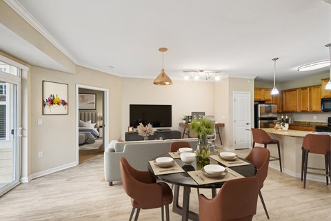 A dining room with a table set for a meal.