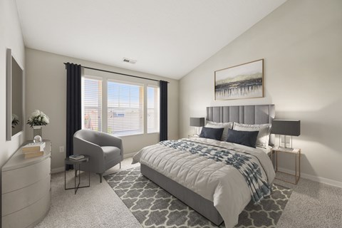 A bedroom with a large bed and a chair.
