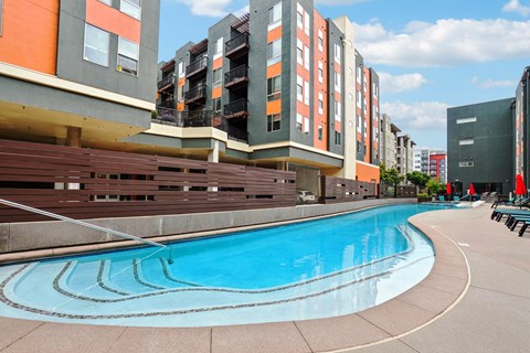 A swimming pool in front of apartment buildings.