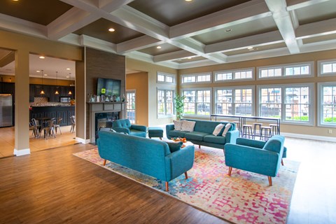 A living room with a blue couch and a rug.