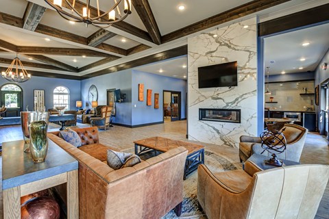 A living room with a brown couch and a fireplace.